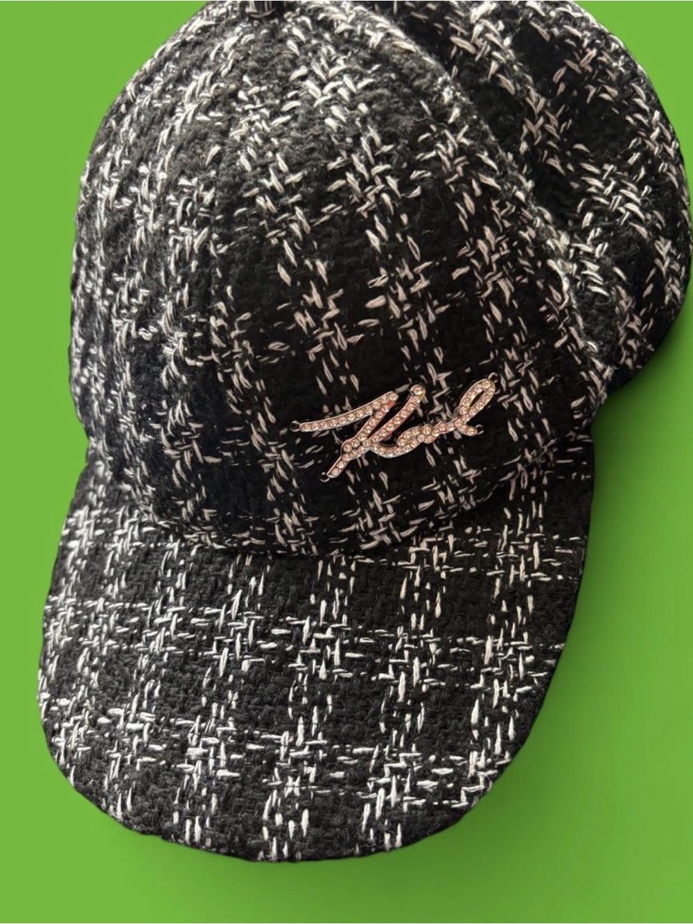 White and black tweed cap with rhinestone logo detail